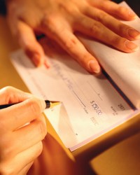 Woman Signing a Check