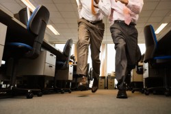 Two Businessmen Running in Office